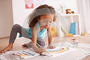 School, education or girl painting a rainbow on classroom floor for creative, learning or child development. Paper