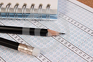 School exam answer sheet and pencil.
