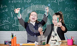 School experiment. School for gifted children. Girls school uniform excited proving their hypothesis. School project photo