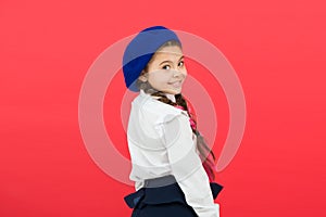 School fashion concept. Schoolgirl wear formal school uniform and beret hat. Child beautiful girl long braided hair