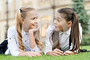 School friends formal clothes relaxing on green grass, communicative skill concept