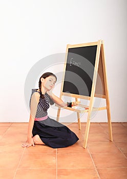 School girl with Albert Einstein equation on blackboard