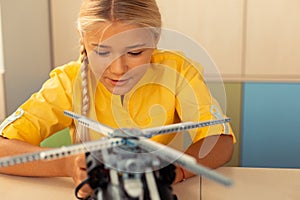 School girl beginning launching a helicopter model.