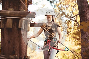 School girl enjoying activity in a climbing adventure park