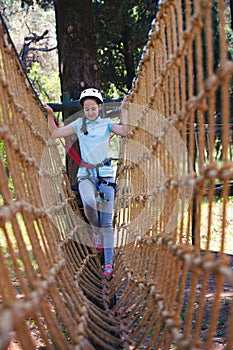 School girl enjoying activity in a climbing adventure park