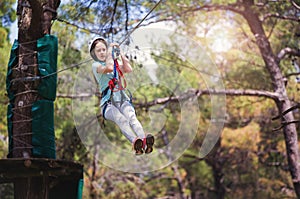 School girl enjoying activity in a climbing adventure park