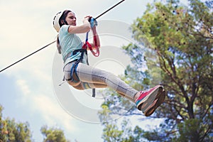 School girl enjoying activity in a climbing adventure park