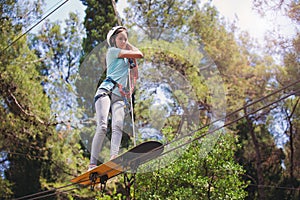School girl enjoying activity in a climbing adventure park