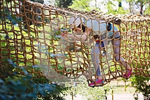 School girl enjoying activity in a climbing adventure park