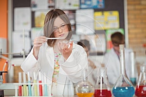 School girl experimenting with chemical in laboratory at school