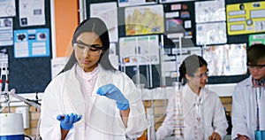 School girl experimenting with chemical in laboratory at school