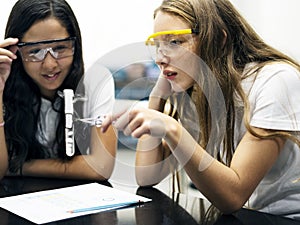 School girl friends learning science in the lab classroom