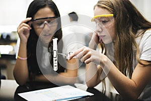 School girl friends learning science in the lab classroom