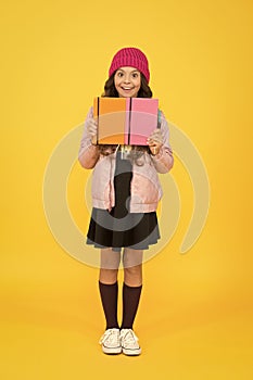 School girl. Happy girl back to school in autumn. Little girl borrow books in library. Small girl smile in formal school