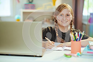 School girl having distance education at home in sunny day