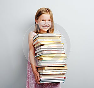 School girl holding stack of books