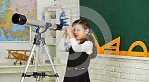 School girl looking through telescope. Little girl using telescope. Telescope on tripod. School subjects set. School