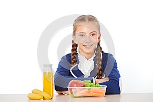 School girl at lunch eating healthy food