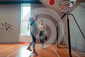 School girl playing basketball with her coach.