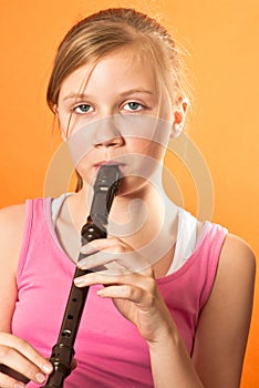 School girl playing the recorder