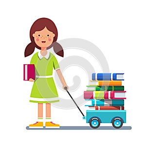 School girl pulling wagon cart with pile of books