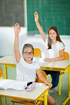 School girl raised hands in class