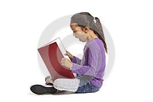 School girl sitting reading book