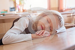 School girl sleeping at the school is sleep at the desk. Student. Pupil studying