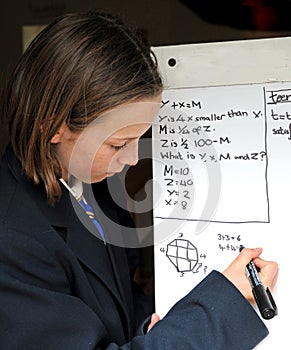 School girl solving maths problem