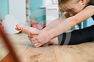 School girl stretch leg at home isolation