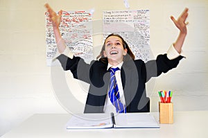 School girl throwing paper in air