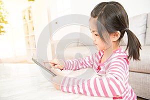 School girl while using digital tablet