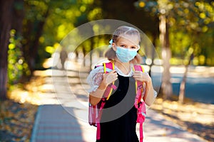 School Girl wearing mask and backpack to protect from coronaviru