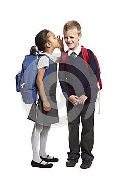 School girl whispering in boys ear