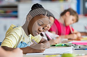 School girl writing in class