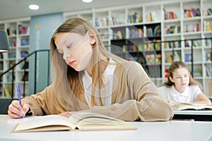 School girl writing in class