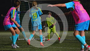 school girls playing football on a stadium at night, school football team, active childhood