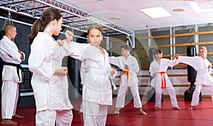 School girls practicing new karate moves in pairs