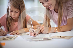 School girls taking exam in classroom