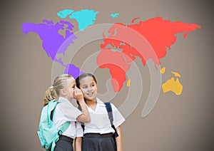 School girls whispering in front of colorful world map