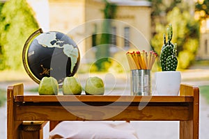 School Globe Composition On Wooden Table Outside