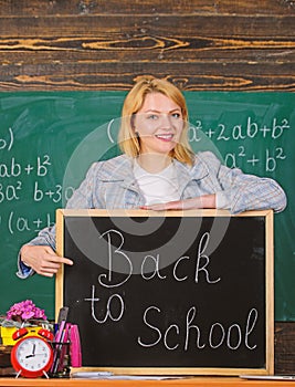School. Home schooling. happy woman. teacher with alarm clock at blackboard. Time. Study education. Modern school