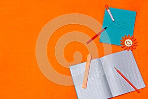 School items on a bright orange background. Copy-space. Place for text. Back to school concept