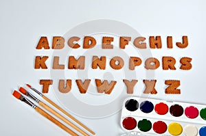 School items, face mask and gingerbread christmas alphabet on white background. gingerbread alphabet letters