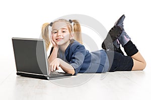 School Kid Girl Learning Computer. Children Online Education Concept. Little Girl lying down over White Studio Background