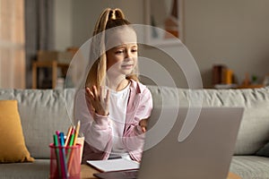 School Kid Girl Making Video Call Talking To Laptop Indoor