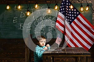 School kid at lesson in 4th of july. E-learning or online courses at home schooling. Patriotism and freedom. Little boy