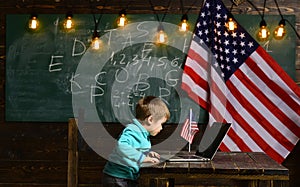 School kid at lesson in 4th of july. Happy independence day of the usa. Little boy with laptop for business at American