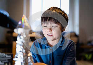 School kid making spaceship for his homework, Happy child boy sitting on the floor playing with rocket toy, Art and craft activity