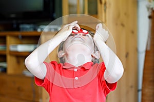 School kid playing with Tri Fidget Hand Spinner indoors